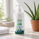 Aloex Aloe Vera moisturizing lotion 500ml on a stone bathroom counter beside a folded white towel and a small aloe vera plant