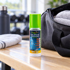Novarnica pain relief spray 65 ml on a wooden bench beside an open gym bag
